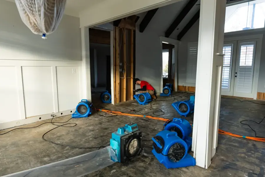 Restoration crew drying a water damaged Joplin, MO home with air movers